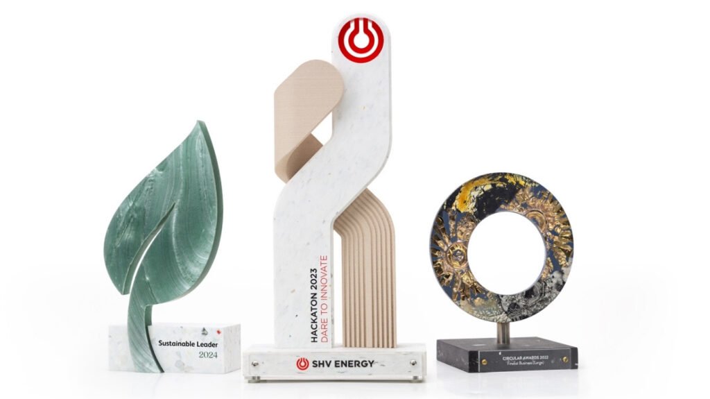 What materials are used in high-end event trophies? 8 3 event trophies of different designs all in a row