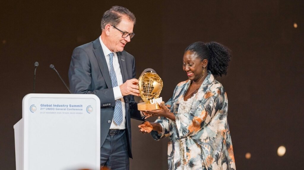 Custom event trophies: The complete guide to designing awards 3 Man at podium awarding woman employee with a trophy