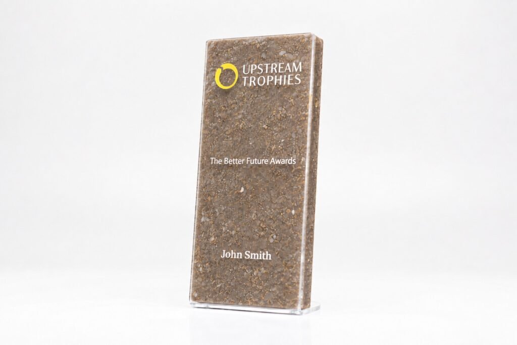 Mijlpaaltrofee met een middelpunt van goudstof, gemaakt van gerecyclede parfumdopjes en een gerecyclede acryl basis